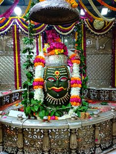 a statue with flowers and garlands around it