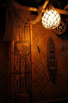 some lights hanging from the ceiling in a room with bamboo walls and rafters on it