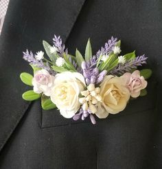 a man wearing a suit and tie with flowers on the lapel flower pinion