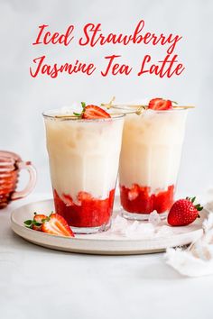 two glasses filled with ice cream and strawberries sitting on a plate next to each other