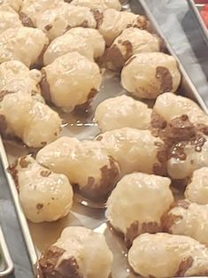 several trays filled with different types of pastries on top of metal pans