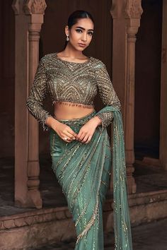 Sage green pre-stitched saree with sequins, crystal embroidery. Paired with a blouse with geometric embroidery using sequins, crystal work. - Aza Fashions Elegant Green Blouse With Sheer Dupatta, Fitted Green Choli For Evening Wear, Fitted Green Choli For Evening, Formal Fitted Green Lehenga, Formal Fitted Green Saree, Fitted Green Formal Blouse, Formal Fitted Green Blouse, Evening Green Blouse Piece With Sheer Dupatta, Green Embellished Evening Blouse Piece