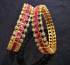 2.8,2.6 size CZ Bangles/Sabyasachi Bangles/Cubic Zirconia Ruby Bangles/Indian Bridal Jadau Bangles/CZ Bangles/Punjabi Wedding Bangles/Bollywood Features Traditional Cubic Zirconia and Pink stones bangles Set Handcrafted To Perfection Light Weight Perfect For Indian Weddings And Celebrations A Beautiful & Memorable Gift for Weddings and Special Occasions Available in 2.6,2.8 size The base metal color is Gold tone brass studded with colorful semi-precious stones on it. Pair of 2 bangles For mo Festive Traditional Bangle With American Diamond, Traditional American Diamond Bangle For Festive Occasions, Gold Bangle With Zari Work For Party, Party Jewelry Bangle With Zari Work, Jeweled Bangle For Wedding And Diwali, Bollywood Jeweled Wedding Bangle, Bollywood Style Jeweled Wedding Bangle, Sabyasachi Bangles, Ruby Bangles Indian