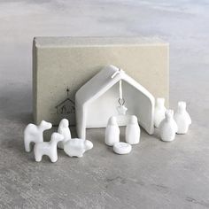 a nativity scene is shown in front of a cement box with white candlesticks