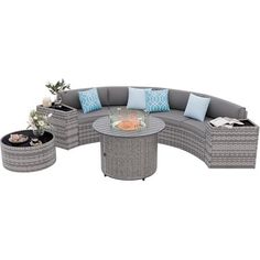 an outdoor furniture set with grey wicker and blue pillows