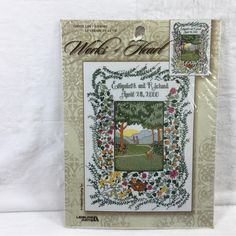 a cross stitch book with an image of trees and flowers