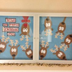 two windows decorated with pictures of reindeers and crosses