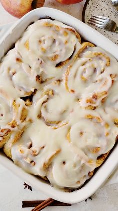 an apple cinnamon rolls in a white casserole dish