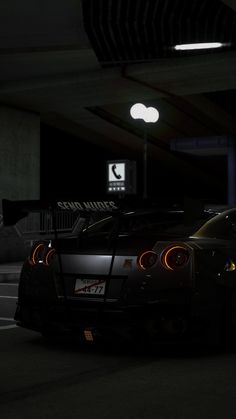 a black sports car parked in a parking garage