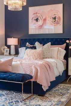 a bedroom with blue walls and pink accents