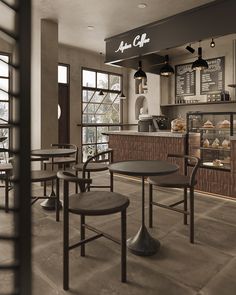 the interior of a coffee shop with tables and chairs