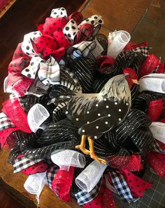 a wreath made out of mesh and fabric with a chicken on it