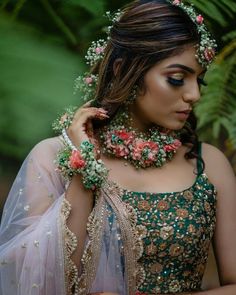 a woman with flowers in her hair and jewelry