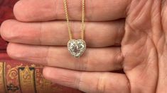 This sparkling diamond necklace features a 14K yellow gold pendant that is accented with one (1) heart brilliant cut diamond set into a three-prong setting. The center diamond is bordered with a halo of twenty-eight (28) prong set round brilliant cut diamonds. The pendant measures 12.2mm by 11.3mm and is suspended from a 14K yellow gold wheat chain that measures 18 inches. Diamond Chandelier, Diamond Heart Pendant Necklace, Diamond Bows, Heart Diamond, Sparkling Diamond, Heart Pendant Diamond, Yellow Gold Pendants, Diamond Set, Diamond Pendant Necklace