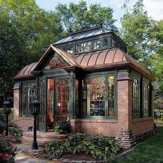 a small brick house with a glass roof