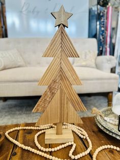 a wooden christmas tree sitting on top of a table