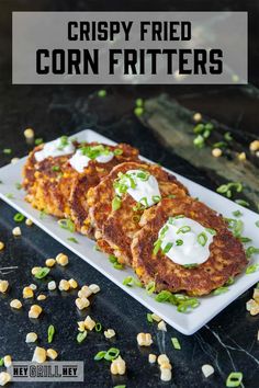 crispy fried corn fritters on a white plate