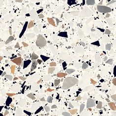 an image of a white and brown floor with black spots on it's surface