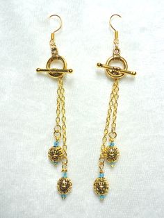 Bright aqua glass beads and goldtone bali beads on delicate goldtone chain and small toggle clasps. 3 1/2" L. All Togglearrings are interchangeable.  $17.49 Artist Jewelry, Aqua Glass, Earring Designs, Artistic Jewelry, Gold Plated Chains, Jewelry Tutorials, Designer Earrings, Handcrafted Jewelry, Beaded Earrings