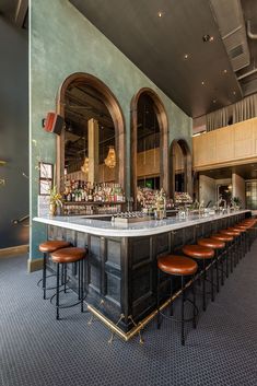 an empty bar with stools in front of it