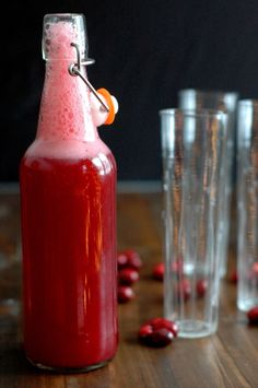 there is a red liquid in the bottle on the table