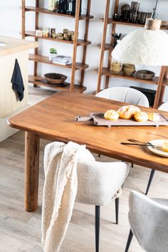 a wooden table topped with plates of food