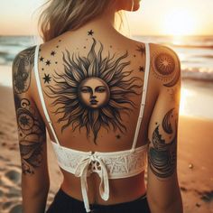 a woman with sun and moon tattoos on her back, standing in front of the ocean