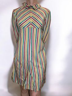 This is a handmade vintage 90s colorful striped midi dress in good vintage condition. It features long sleeves with yellow buttons and a back zipper closure. The dress is multi-colored with vibrant stripes, adding a cheerful and retro touch to your wardrobe. Measurements: Length: 92 cm (approximately 36.2 inches) Bust: 48 cm (approximately 18.9 inches) Waist: 44 cm (approximately 17.3 inches) Sleeve Length: 52 cm (approximately 20.5 inches) Please view all photos carefully for more details. Retro Striped Knee-length Dress, Retro Long Sleeve Multicolor Dress, Retro Multicolor Long Sleeve Dress, Retro Long Sleeve Striped Dress, Retro Striped Midi Dress, Vintage Long Sleeve Striped Dresses, Wardrobe Measurements, Striped Midi Dress, Dress Clothes For Women