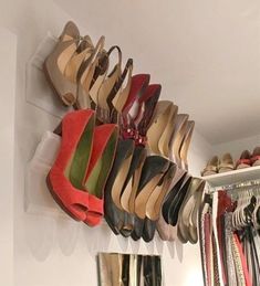 there are many pairs of shoes hanging on the wall