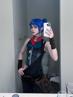 a woman with blue hair is taking a selfie in the mirror while holding her cell phone