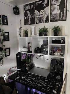 a black and white desk with lots of pictures on the wall