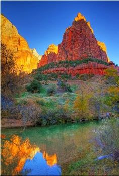 the mountains and trees are reflected in the still water at this scenic location, which is also known for its red rock formations