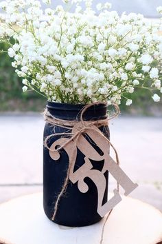 a mason jar filled with baby's breath flowers