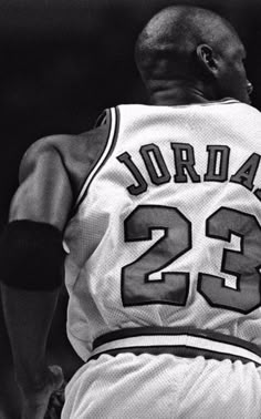 an old photo of a basketball player with the number 22 on his jersey and numbers 23 on his shirt