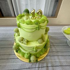 a green cake sitting on top of a table