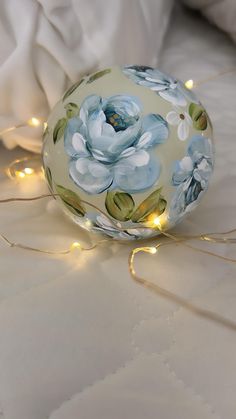 A hand painted ornament with blue cabbage roses, greenery, and florals that wrap all the way around.  It is a 3 inch ornament and painted with acrylic paints.  Would be perfect for gift giving.  Merry Christmas! Painted Ornament, Hand Painted Christmas, Painted Christmas Ornaments, Cabbage Roses, Painted Ornaments, Hand Painted Ornaments, Acrylic Paints, Glass Painting, Gift Giving