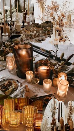 a table topped with lots of different types of candles