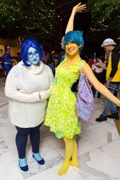 two women dressed in costumes pose for the camera