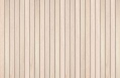 a wood paneled wall with vertical stripes in white and light brown colors, closeup