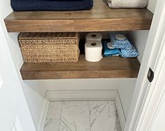 the shelves in this bathroom are filled with towels