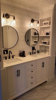 a bathroom with two sinks and mirrors on the wall