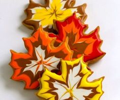 three leaf shaped cookies sitting next to each other on top of a white countertop