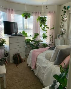 a bedroom with lots of plants in it