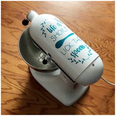 a close up of a blender on a wooden table with writing on the side