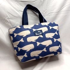 Lunch By The Sea Insulated Bag Have A Whale Of A Time Bringing Your Lunch In This Cute Insulated Bag. Canvass Type Fabric With Familar Whale Print Size 13 X 8 X 4.5 Approximate Light Weight And Easy To Pack Handle Drop 5 Inches Blue Tote Lunch Bag For Travel, Blue Large Capacity Bucket Canvas Bag, Casual Blue Lunch Bag For Travel, Casual Blue Travel Lunch Bag, Blue Tote Lunch Bag For Daily Use, Large Capacity Blue Lunch Bag For School, Blue Rectangular Lunch Bag For Daily Use, Casual Blue Lunch Bag For Everyday Use, Casual Blue Rectangular Lunch Bag