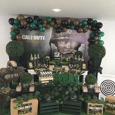 a table with balloons and decorations for an army themed party