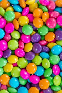 many different colored candies in a pile