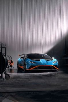 a blue and orange sports car parked in a garage