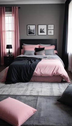 a bedroom with pink and grey bedding, black curtains and pictures on the wall