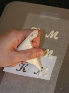 someone is cutting out the letters with a pair of scissors on top of a piece of paper